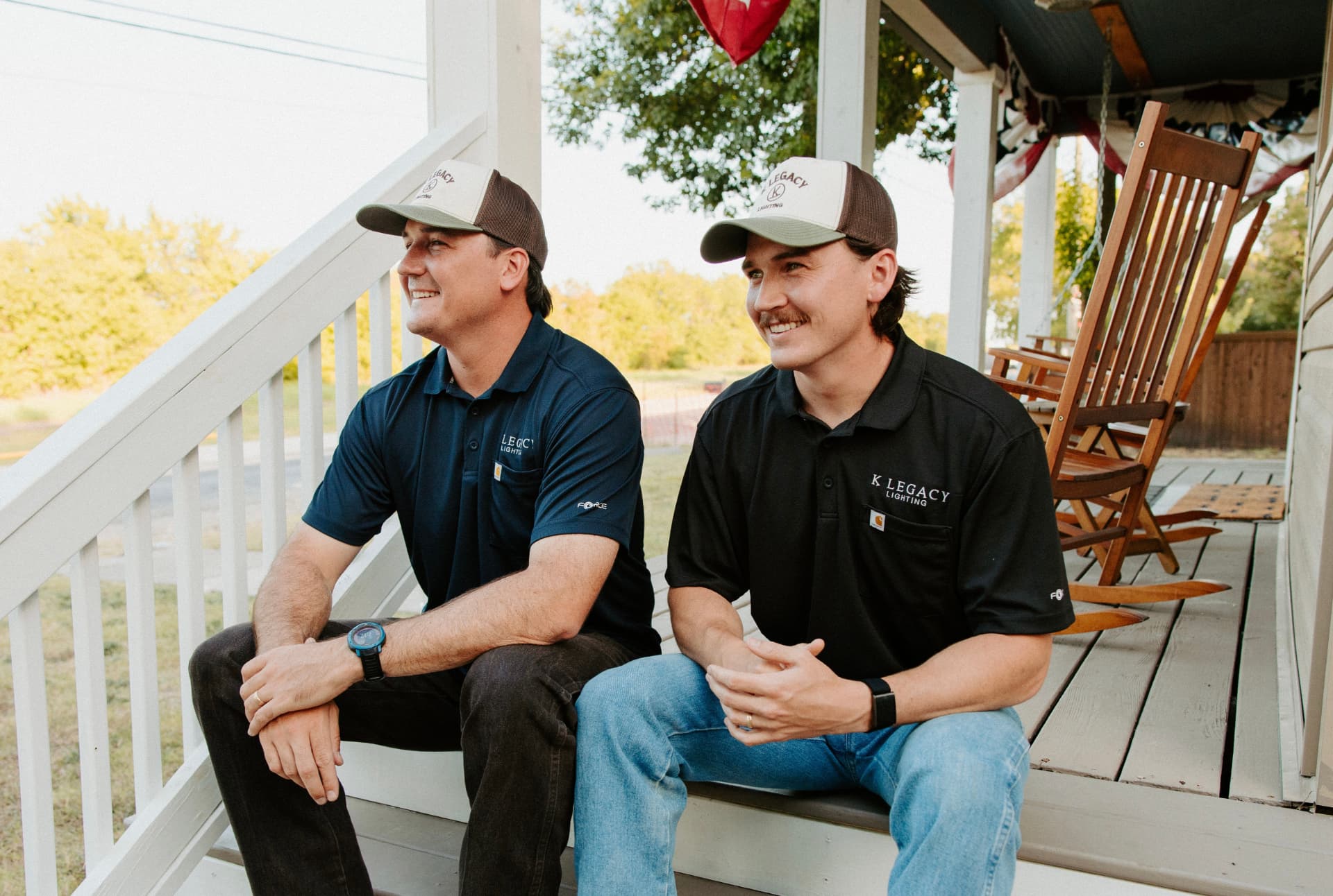 Ethan and Zach Knowles sitting on the porch in K Legacy Lighting hats